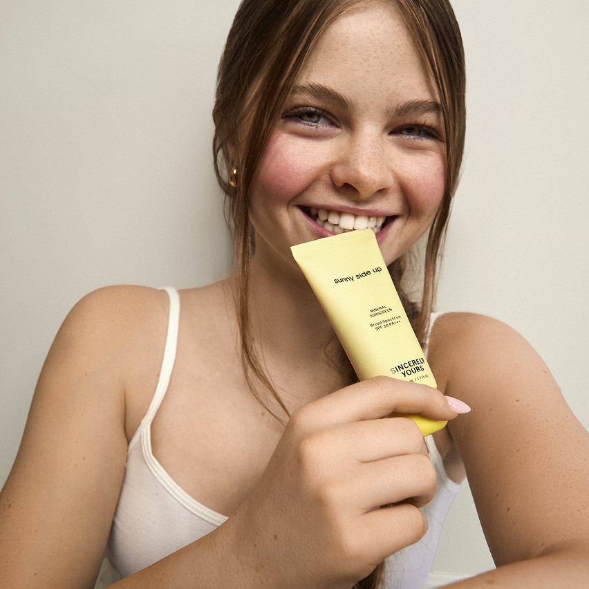 Salish holding tube of Sunny Side Up SPF